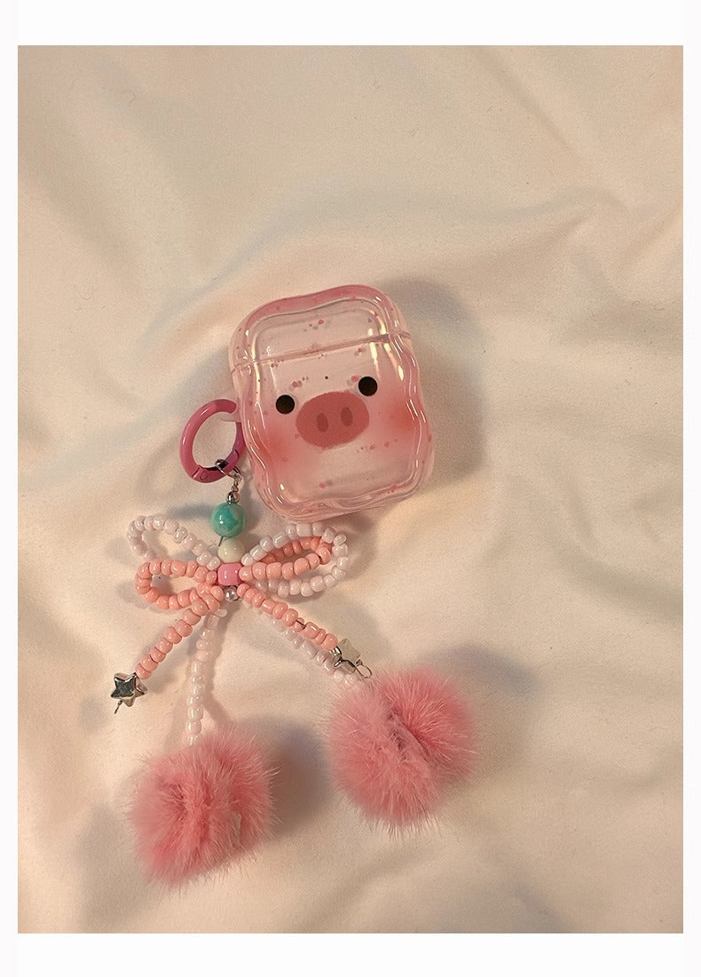 Close-up of the transparent cartoon pig Apple headphone case on a textured surface, showcasing its cute design and high-quality materials.