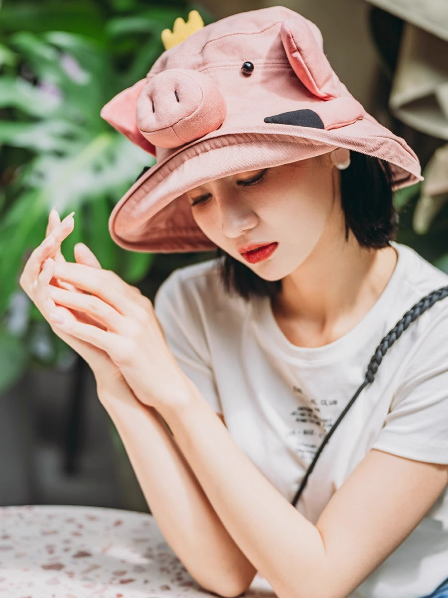 Breathable cotton cartoon pig bucket hat with UV protection for sunny days.