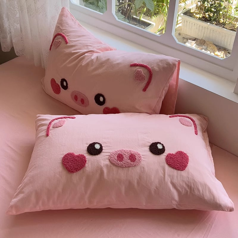 Close-up of Cartoon Pig Bedding Set's vibrant pillowcases featuring whimsical pig designs.