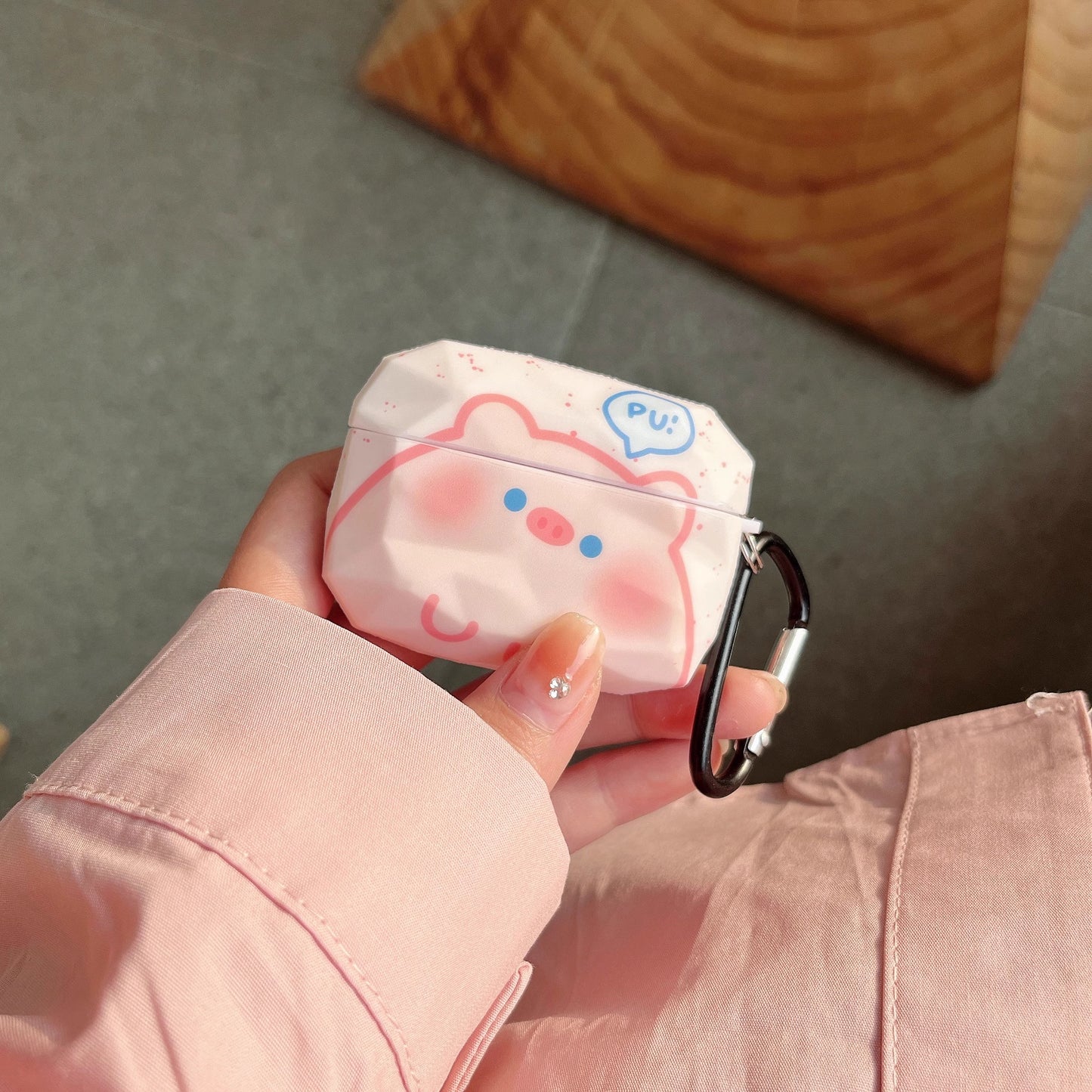 Adorable pink pig earphone case providing durable protection for Apple earbuds.