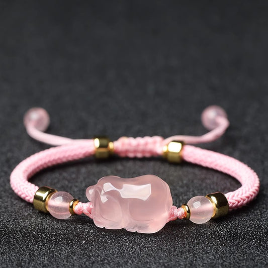 Lucky Pink Crystal Pig Bracelet showcasing its vibrant pink crystals and adorable pig design, ideal for attracting positivity and good fortune.