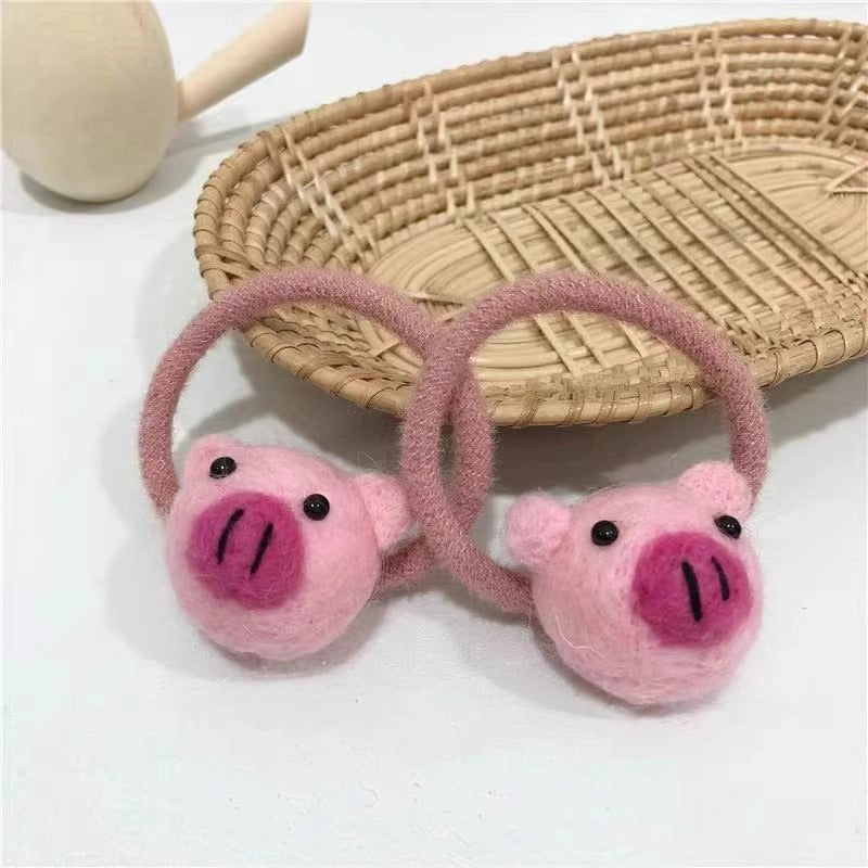 Soft plush pig hair tie providing a secure hold without damage