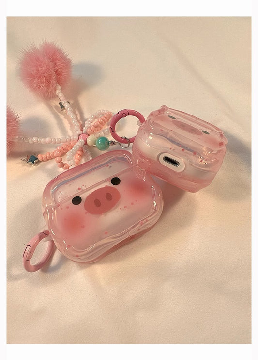 Transparent cartoon pig Apple headphone case displayed on a colorful table, showcasing its playful and whimsical design.