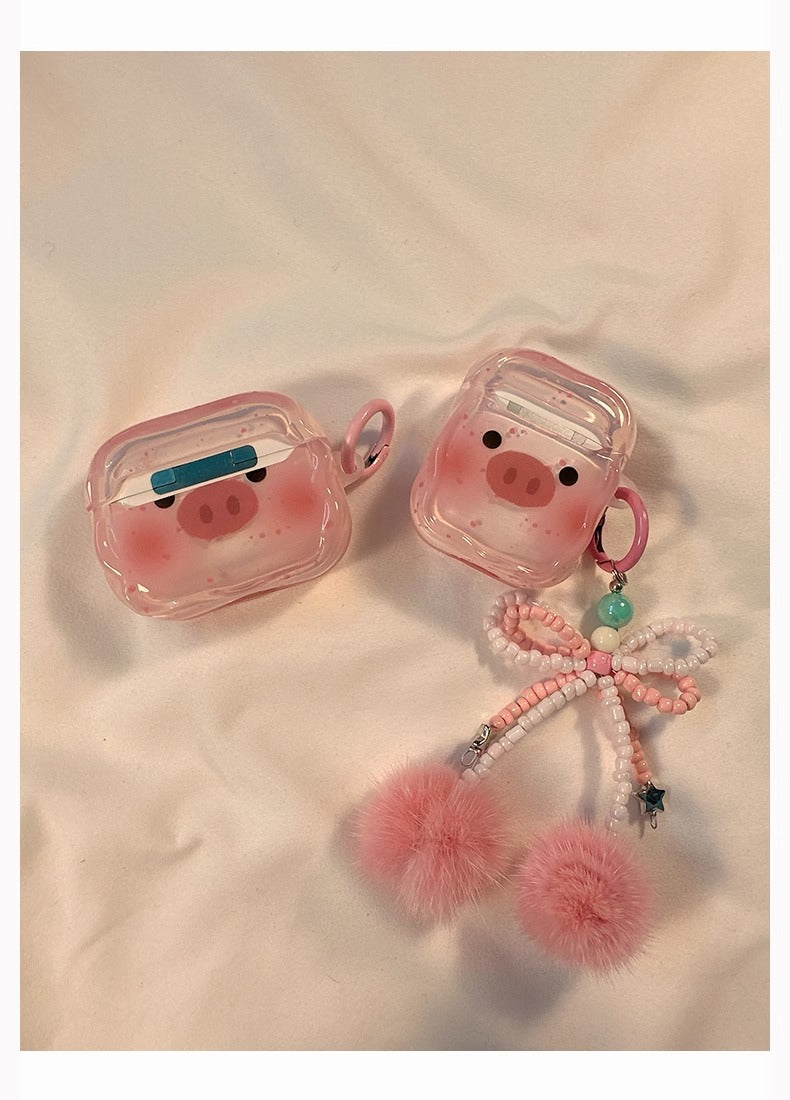 Lifestyle shot of the transparent cartoon pig Apple headphone case with accessories, emphasizing its fun and trendy appeal.